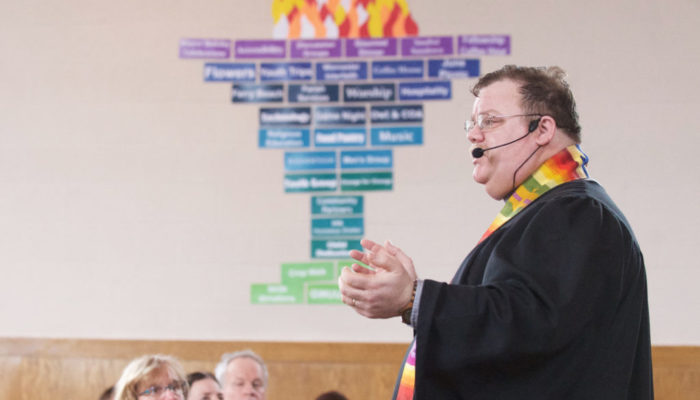 Rev Aaron Payson delivers his reflection during a Sunday service