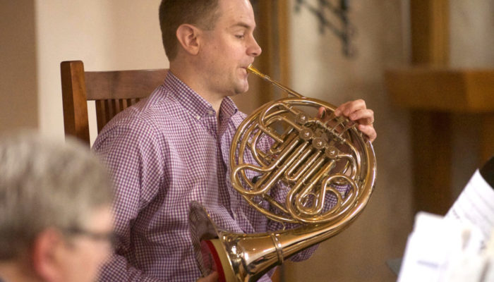 Matt Bejune plays French horn during an Easter Sunday service