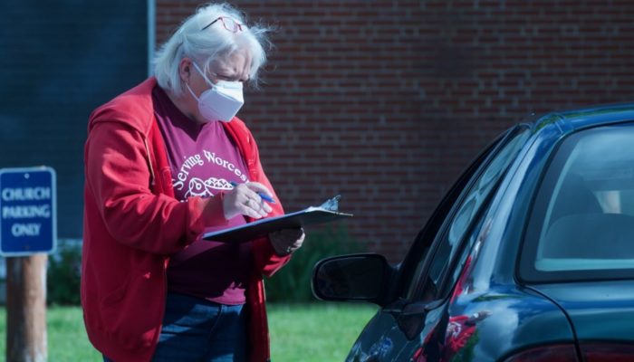 Volunteers provide curbside pickup at the food pantry during COVID 19