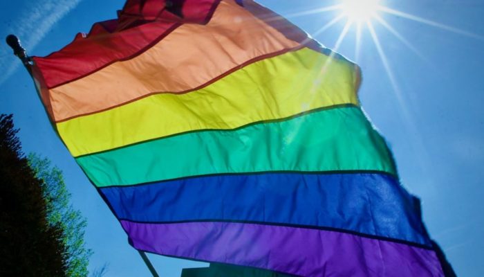 Rainbow flag flying in sunshine