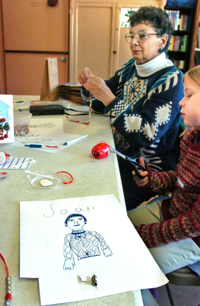 Joan Webster at a table with children