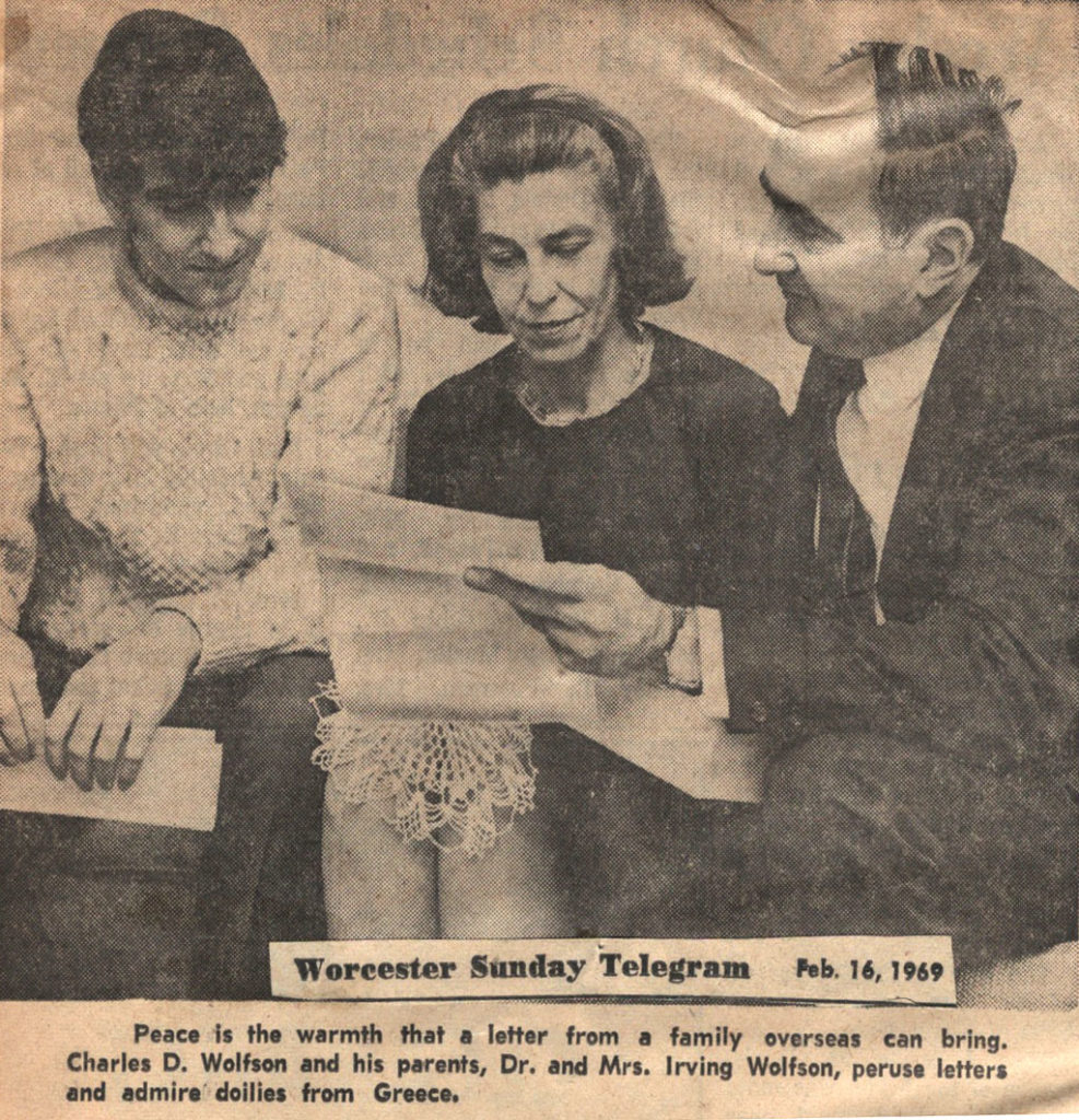 newspaper article  from Worcester Sunday Telegram dated feb. 16, 1969 - caption reads Peace is the warmth that a letter from a family overseas can bring. Charles D. Wolfson and his parents, Dr. and Mrs. Irving Wolfson peruse letters and admire doilies from Greece
