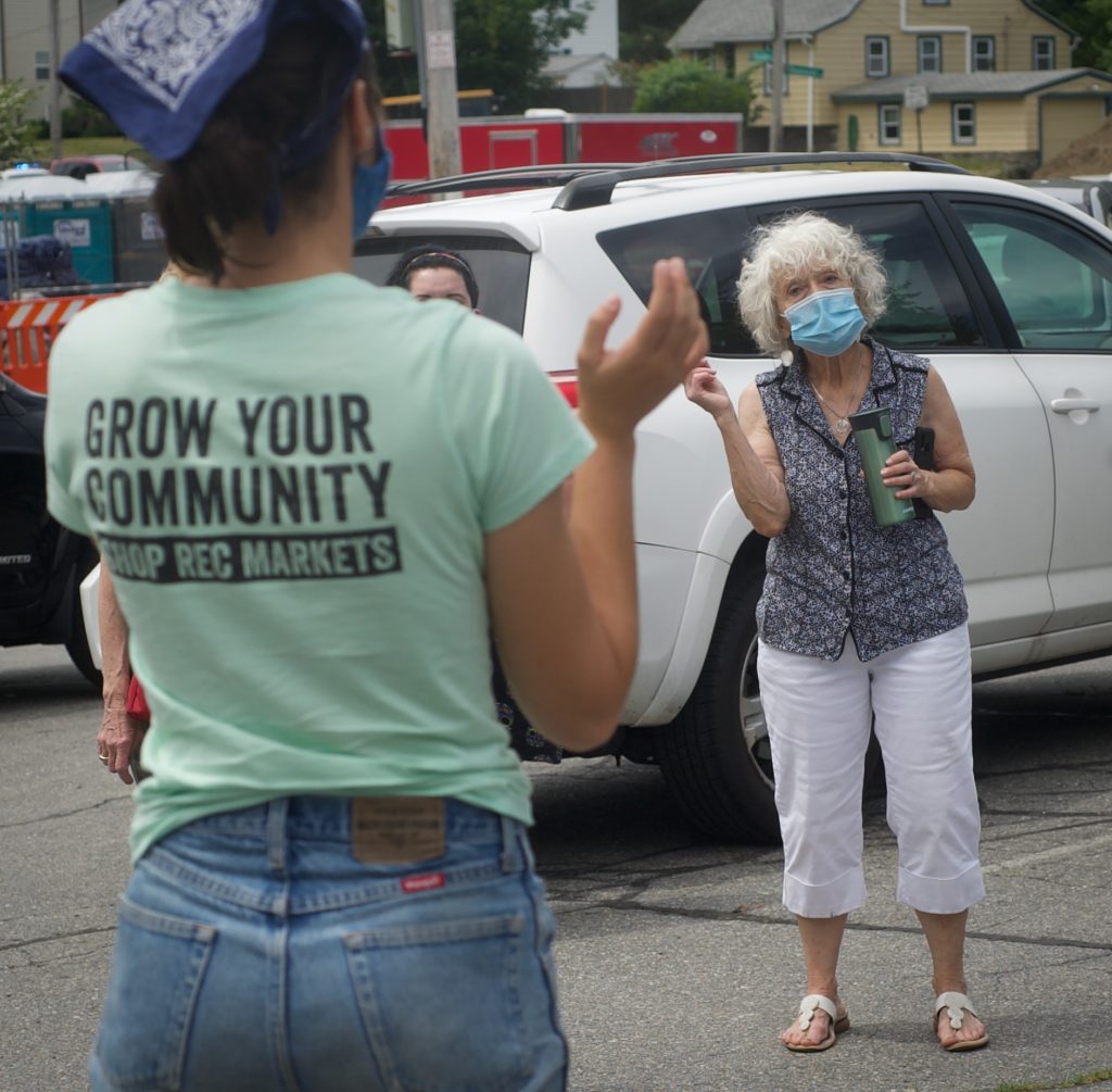 Linda Morse, right, listens as Anna Marinescu, REC Regional Manager, instructs shoppers before the Mobile Farmers Market opens on Thursday, June 25, 2020.