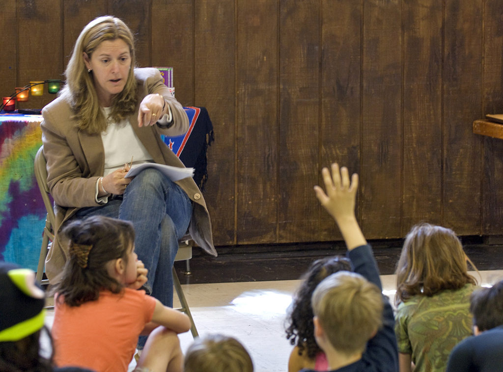 RE 08-09 President Denise Darrigrand explains the UUCW Food Pantry to the children.
