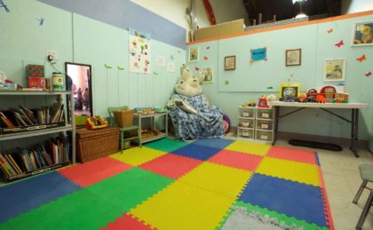 Nursery room with colorful floor & toys